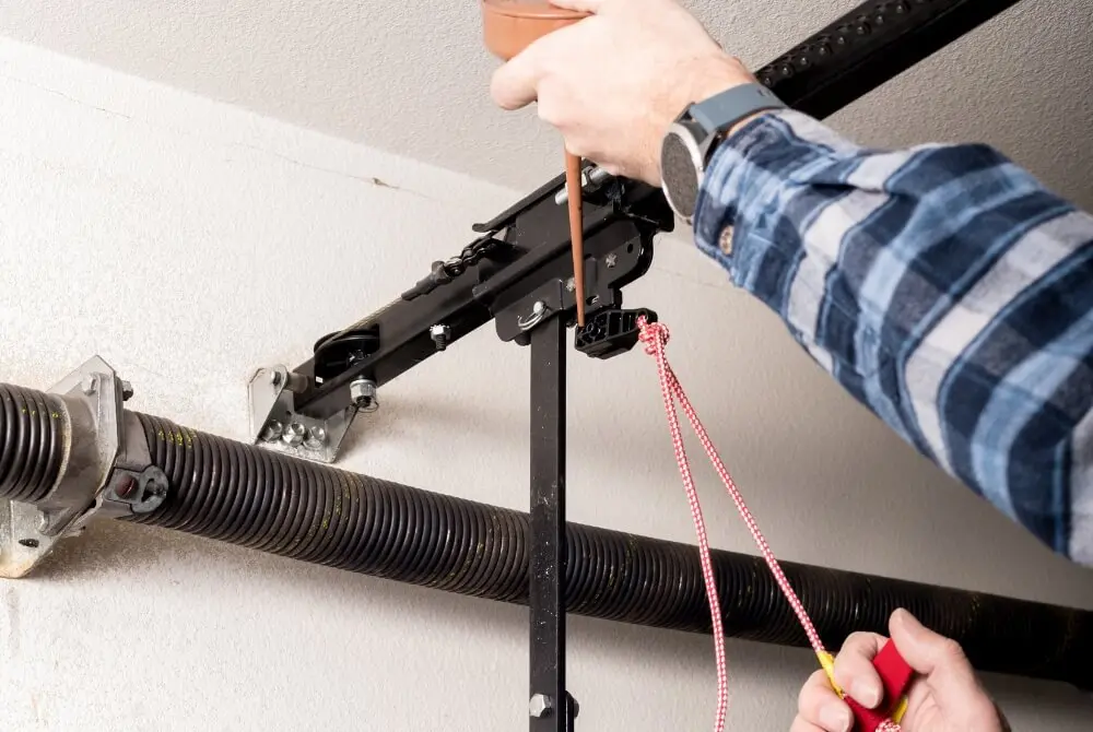 Garage door specialist fixing a damaged garage door