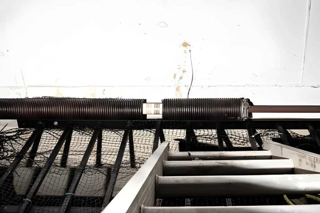Garage Door Repair in Erie showing professional garage door spring replacement service in a residential Erie home